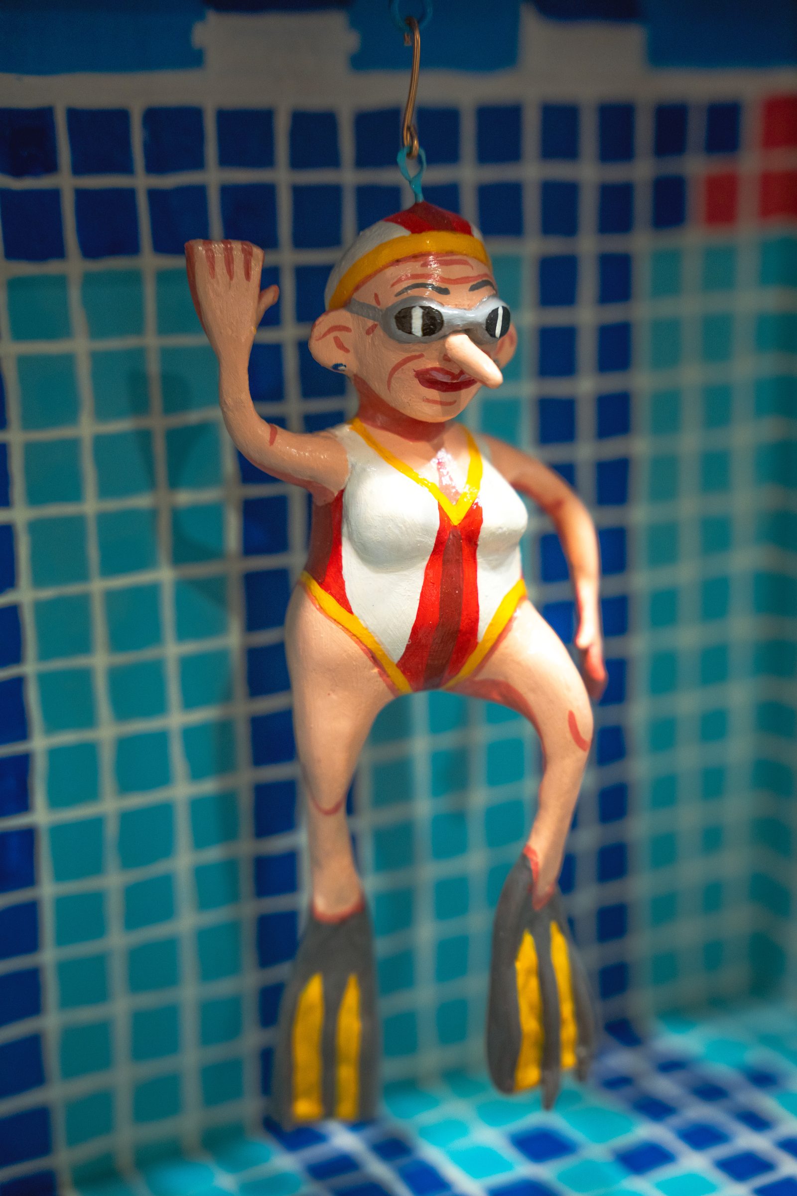 A figure in a swimsuit and flippers, suspended underwater